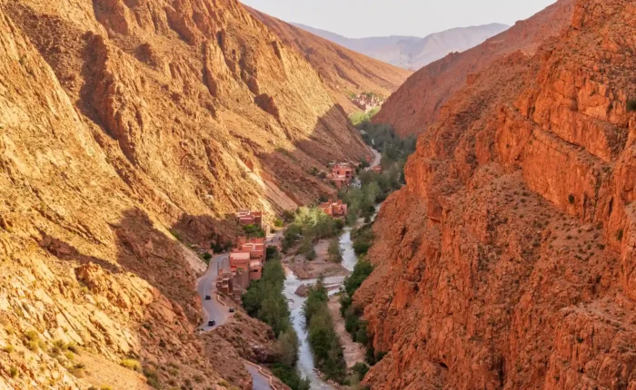Springtime in Morocco’s Atlas Mountains Dades Valley A vibrant, green valley in Morocco during spring, with blooming wildflowers in Atlas Mountains Dades Valley.